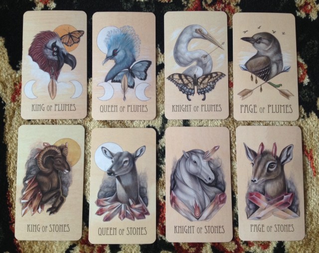 Wooden Tarot Courts: Plumes (Swords) and Stones (Wands).